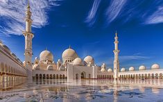 a large white building with many towers and domes