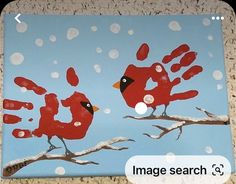 a painting of two red birds on a tree branch