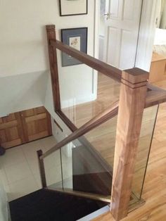 a wooden stair case with glass railing