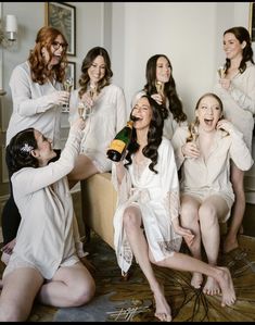 a group of women sitting around each other drinking champagne