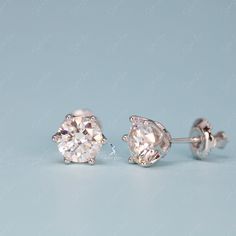 These simple yet stunning Moissanite stud earrings from The Silver Luna are the perfect diamond alternative gift. Moissanite gemstones sparkle with more fire and brilliance than mined diamonds, but at a fraction of the cost. Each earring features a 0. or 1 carat equivalent Moissanite gemstone set on solid 925 sterling silver bases. Whether you're shopping for an engagement gift, anniversary present or just looking to treat yourself, these Moissanite earrings provide dazzling beauty and lasting v Diamond Cut Diamond Earrings, Gift Moissanite Earrings With Round Cut, Moissanite Round Cut Earrings For Gift, Solitaire Diamond Round Earrings, White Gold Earrings With Prong Set White Topaz, Round Cut Moissanite Earrings For Gift, Diamond Cut White Topaz Earrings In Fine Jewelry Style, Fine Jewelry White Topaz Diamond Cut Earrings, White Gold White Topaz Earrings With Prong Setting