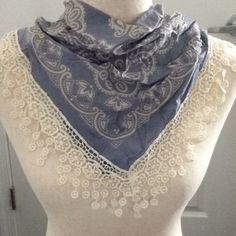 a white mannequin wearing a blue scarf on top of a dress dummyt