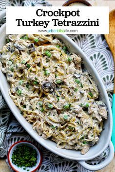 a white casserole dish filled with chicken and pasta