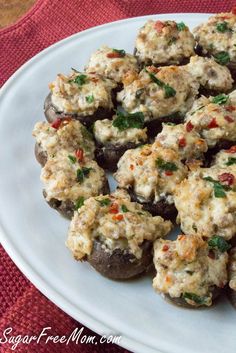 stuffed mushrooms with cheese and herbs on a white plate