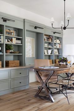 a dining room table and chairs in front of bookshelves with built - in shelves