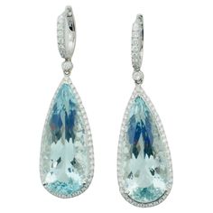 Aquamarine and Diamond Dangling Drop Earrings in 18k White Gold 2 Pear Shape Cut Aquamarines Weighing 30.00 Carats Approximately 125 Round Brilliant Cut Diamonds Weighing 1.50 Carats Approximately Aquamarine and Diamond Dangling Drop Earrings in 18k White Gold are a stunning pair of earrings that exude elegance and refinement. The earrings are crafted from 18k white gold, which provides a bright, polished finish and a perfect background for the gemstones. The earrings feature 2 pear shape cut aq Luxury Hallmarked Pear-shaped Diamond Earrings, Formal Platinum Gemstone Earrings, Formal Platinum Earrings With Gemstone, Luxury Teardrop Gemstones, Luxury Pear-shaped Gemstone Diamond Earrings, Gia Certified Drop Jewelry For Formal Occasions, Perfect Background, Aqua Marine, Diamond Drops