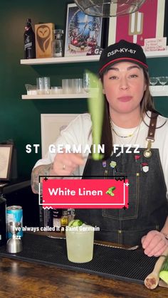 a woman behind a counter with a drink in front of her and the words white linen on it