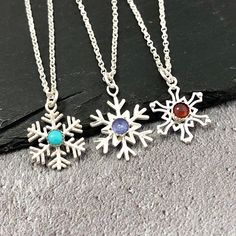 A pretty sterling silver snowflake birthstone necklace would make the perfect birthday, anniversary or Christmas gift.  You have a choice of three of snowflake shapes A, B or C and then I've listed many gemstone options as I can in the drop down menu. If there is something you would like but can't see please don't hesitate to get in touch. January 1A ~ classic red garnet  1B - rhodolite purple/red garnet (not listed so message if you'd prefer this) February  2 ~ amethyst March 3 ~ aquamarine Apr Snowflake Shapes, Grey Moonstone, Snowflake Shape, Necklace Birthstone, Snowflake Pendant, Silver Snowflakes, White Moonstone, Blue Moonstone, April 4