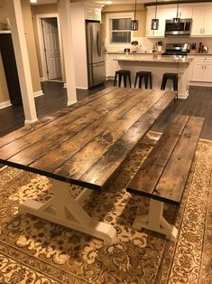 a large wooden table sitting in the middle of a kitchen