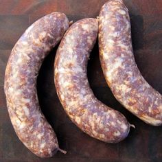 three sausages sitting next to each other on a table