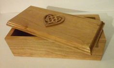 a wooden box with a carved heart on it