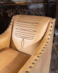 a leather chair with an intricate design on it