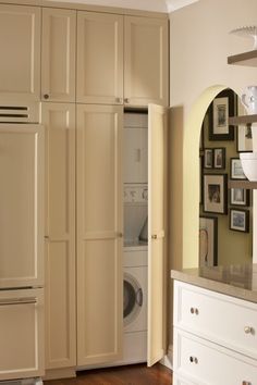 a washer and dryer in a room with pictures on the wall