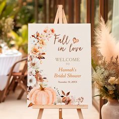 an easel with a sign that says fall in love welcome to hannah's bridal shower