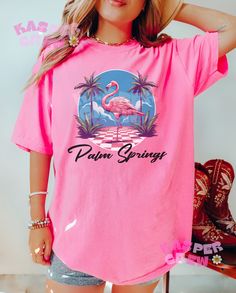 The Comfort Colors 1717 "Palm Springs" Shirt, where tropical vibes and laid-back style meet in perfect harmony. This delightful t-shirt captures the essence of sunny Palm Springs with a playful twist, showcasing vibrant palm trees and a majestic flamingo. Designed with your utmost comfort in mind, the Comfort Colors 1717 Shirt is crafted from premium, pre-shrunk cotton fabric that feels incredibly soft against your skin. Its relaxed fit allows for unrestricted movement, making it an ideal choice Comfort Colors Shirt, Perfect Harmony, Spring Shirts, Tropical Vibes, Laid Back Style, Beach Days, Palm Springs, Beach Day, Comfort Colors