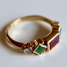 Named in homage to the Italian artist and goldsmith, this design features a garnet, emeralds and 0.11 carats of diamonds accents mounted in a renaissance style setting. 14k gold - available in sizes 5-8. Heirloom Diamond May Birthstone Ring, Heirloom Diamond Birthstone Ring For May, Heirloom Emerald Cut Birthstone Diamond Ring, Heirloom Emerald Cut Diamond Ring With Birthstone, Elegant Multi-stone Emerald Ring Gift, Heirloom Yellow Gold Multi-stone Diamond Ring, Elegant 14k Gold Emerald Ring With Diamond Accents, Emerald Cut Emerald Ring With Multi-stone Diamond, Emerald-cut Multi-stone Diamond Emerald Ring