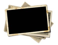 an old photo frame is stacked on top of several other frames, with one black square in the middle