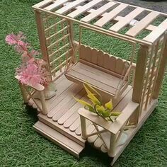 a small wooden structure with flowers in it