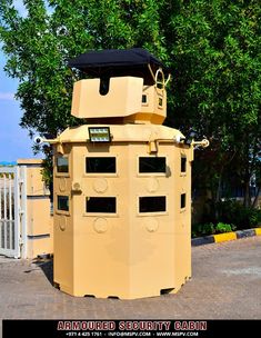 a large yellow box sitting on the side of a road