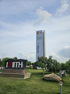 there is a large monument in the middle of a field with an olympic sign on it