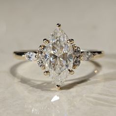 a diamond ring with three pear shaped diamonds