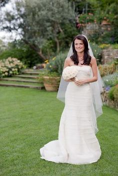 a woman in a wedding dress holding a bouquet