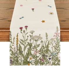 an image of a table runner with flowers on it and butterflies in the sky above