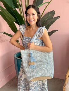 Feeling blue never looked so good! America & Beyond - Natural Beauty Upcycled Hand-Woven Light Blue Tote is here to add a splash of eco-friendly fun to your life. This multi-purpose tote, crafted from hand-weaving fabric with a lurex, is perfect for any adventure. With double shoulder straps adorned with lace details and a playful pom pom tassel charm, it's super stylish & so easy to carry. Inside, you'll find a hanging zip pocket for your essentials and a magnetic button closure to keep everyth Eco-friendly Blue Beach Bag For Vacation, Blue Recyclable Beach Bag For Summer, Blue Handwoven Summer Beach Bag, Eco-friendly Blue Beach Bag For Beach Season, Blue Recyclable Beach Bag For Travel, Blue Cotton Beach Bag For Summer, Blue Cotton Beach Bag For Vacation, Eco-friendly Blue Tote Beach Bag, Blue Cotton Summer Beach Bag