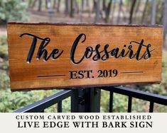 a wooden sign that says the cossarts est 2019 on it, with trees in the background