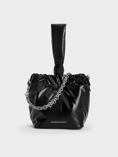 If you are looking for a stylish yet functional mini bag to accompany you on errand runs and lunch breaks, this Caia dumpling bag in timeless black may be it. Featuring a handy drawstring closure and a distinctive knotted handle, this piece is a fabulous companion when you want to travel light. It is also equipped with a glamorous chain handle and a detachable strap that you can adjust to your desired length. Carry it in hand or sling it across your body, this cute carrier will look just as good Chic Bucket Bag With Handle Drop, Versatile Bucket Bag Pouch, Pouch Bucket Bag With Handles For Evening, Chic Bucket Bag With Top Carry Handle, Chic Pouch Bucket Bag With Adjustable Handle, Black Bucket Bag With Handle Drop For Evening, Dumpling Bag, Drawstring Bucket Bag, Charles Keith