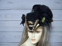 Beautiful ladies black tricorn with golden tan satin pleated trim with black and gold braid. Black cocarde with a hand painted floral accent, black ostrich feathers and black satin bows. Please measure your head before purchasing as I do not take returns and all sales are final. The inside circumference is 22.5" with a built-in adjustable string. Just cinch and tie for a better fit. Perfect for Renaissance Fairs, Gasparilla Pirate event, 1800's Victorina events or even Halloween. Check out my other hats and fascinators in my shop. Please let me know if you have any questions.   All sales are FINAL, no returns or exchanges please keep this in mind before purchasing. 1800s Style, Tricorn Hat, Pirate Hat, Satin Noir, Hats And Fascinators, Golden Tan, Pirate Hats, Costume Hats, Ostrich Feathers