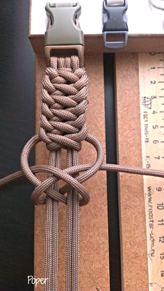 two different types of cords are tied together in a box with measuring tape on the side