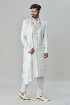 White sherwani with floral, thread and sequins embroidery. Comes with churidar and a dupatta. - Aza Fashions White Sherwani With Zari Work For Designer Wear, Designer White Sherwani With Zari Work, Designer Straight Kurta Sherwani In White, Designer Wear White Sherwani Straight Kurta, Designer White Sherwani Straight Kurta, White Straight Sherwani For Designer Occasions, White Churidar For Eid Reception, Designer White Sherwani With Resham Embroidery, White Churidar For Reception Or Eid