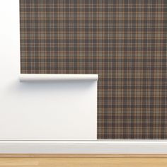 a brown and tan plaid wallpaper with a white shelf in the corner next to it