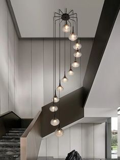 a bunch of lights hanging from the ceiling in a room with some stairs and steps