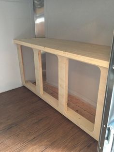 the inside of a trailer with wooden shelves