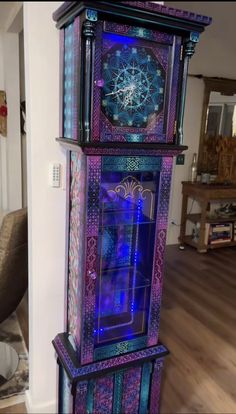 a tall clock tower sitting on top of a hard wood floor