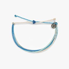 It’s the bracelet that started it all. Each one is handmade, waterproof and totally unique—in fact, the more you wear it, the cooler it looks. Grab yours today to feel the Pura Vida vibes. - 100% waterproof- Wax-coated- Adjustable from 2-5 inches in diameter- Because jewelry products are handcrafted by artisans, dimensions may vary from piece to piece Founded in Costa Rica, Pura Vida Bracelets provides sustainable jobs to artisans worldwide and raises awareness for charities with products that g Clear Spring, Bracelet Inspired, Preppy Jewelry, Shades Of Light Blue, Pura Vida Bracelets, Birthday List, Birthday Wishlist, Pearl Shell, Blue Skies