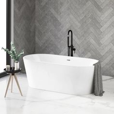 a white bath tub sitting in a bathroom next to a window with a plant on it