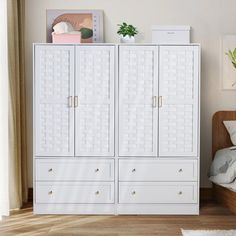 a bedroom with a bed, dresser and white cabinet in the corner next to a window