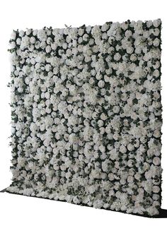 white flowers are arranged on the side of a flower wall with black trimmings