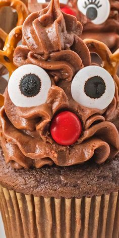 a cupcake with chocolate frosting and googly eyes