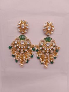 Silver Moissanite Polki With Labmade Emerald Earring, Indian Wedding Jewellery, Polki Chandbali, Indian Traditional Jewellery, Chandbali *𝐀𝐛𝐨𝐮𝐭 𝐏𝐫𝐨𝐝𝐮𝐜𝐭* Product Code :- TR 1034   Product Type :- Chandbali Earring Product Weight :- 28.860 Gram Gemstone Used :- Moissanite Polki, Cubic Zirconia, Labmade Emerald Material :- 925 Sterling Silver, Moissanite Polki, Cubic Zirconia, Labmade Emerald Size :- 5x3 Cm Intricate, hand-crafted, Pure Silver Polki Earrings, studded with high-quality Moissanite Polki comes with Push-Back, made in 92.5 silver with 22ct gold plating. The product comes with 92.5 silver stamping -Product can be made in gold as well. -If any product is not ready, It takes 2-3 weeks to make in pure silver -We also look forward to Bulk Orders. We shall consider special Polki Chandbali, Indian Traditional Jewellery, Silver Stamping, Indian Wedding Jewellery, Earring Indian, Emerald Earring, Polki Earrings, Traditional Jewellery, Chandbali Earrings