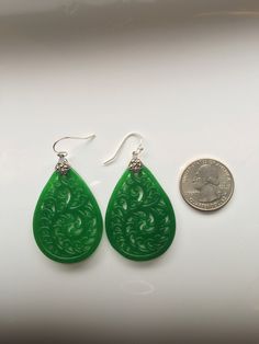 A pair of vintage green carved jade earrings comes with 925 sterling silver hooks. The big emerald-like green jade drops are heavy duty and being carved into full delicate tree/leaf details. The laced teardrop designs bring you a taste of ancient Chinese royal feel. Some highlights of this elegant and fancy dangle silver jade earrings are: *High-quality materials Quality green jade, delicate carving details, 925 sterling silver. Makes perfect gift for yourself or friends. *Vintage Chinese style Green Teardrop Pierced Earrings As A Gift, Green Teardrop Pierced Earrings For Gift, Green Oval Hypoallergenic Earrings, Green Jade Earrings For Pierced Ears, Teardrop Jade Earrings, Hypoallergenic Green Oval Earrings, Handmade Oval Jade Earrings, Handmade Teardrop Jade Earrings, Handmade Jade Teardrop Earrings