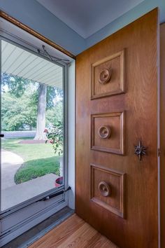 a wooden door with knobs is open