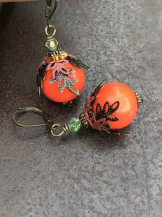 Orange Boho Earrings, Bohemian Earrings, Autumn colors, Fall Dangle Earrings, Leaves Earrings, Handmade Jewelry, Gift Ideas for her, women Hello, This is a handmade item made by myself. I love these,, they are very unique and beautiful. They make a perfect handmade gift for any occasion. Color : Orange Finish : Acrylic bead, hand-painted metal Size : Approximately 1.75 inches with the lever back ear wires included. Ear wires : antiqued bronze lever back ear wires The earrings will arrive in a co Elegant Nickel-free Orange Earrings, Elegant Orange Nickel-free Earrings, Handmade Elegant Orange Beaded Earrings, Elegant Handmade Orange Beaded Earrings, Orange Beaded Drop Earrings For Pierced Ears, Orange Bohemian Jewelry For Pierced Ears, Party Orange Earrings With Ear Wire, Unique Orange Metal Earrings, Vintage Orange Round Earrings