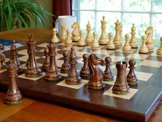 a wooden chess board with pieces on it and the words premium pieces written in white