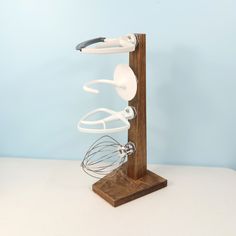 a wooden stand with an electric whisk on it