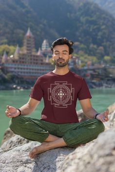 Here's our newest fun tshirt design: A Cozy Yoga Festival Shirt with the Moon Phases. Perfect for maditative souls!  The Sri Yantra holds great significance. It symbolizes the union of masculine and feminine divine energies. The triangles, varying in size, form 43 smaller triangles in concentric levels, mirroring the cosmos. And yes we added the moon phases for the astral and spiritual voyager.  If you like this shirt... Don't wait, just get it before we decide to stop listing this one!  ### How Cotton Relaxed Fit Top For Meditation, Relaxed Fit Graphic Print Tops For Meditation, Crew Neck Cotton Shirt For Festivals, Graphic Print Short Sleeve Tops For Yoga, Graphic Print Short Sleeve Tops For Festivals, Cotton Crew Neck T-shirt For Festivals, Festival Graphic Tee With Screen Print, Graphic Tee Tops For Festivals With Short Sleeves, Festival Short Sleeve Graphic Tee Tops