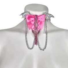 Choose the color elastic, bow, wing, and hardware you want to recreate this look to fit your style! Adjustable neck band. Petal Pink elastic, halo wings, medium pink bow, crystal rhinestones, silver chains, and silver hardware pictured here. Satin Elastic • Adjustable Straps • Hand Wash • Air Dry Pink Punk Jewelry For Party, Adjustable Pink Jewelry For Cosplay, Pink Party Jewelry With Butterfly Knot Detail, Pink Party Jewelry With Butterfly Knot, Thigh Garter, Leg Garters, Silver Chains, Pink Bow, Silver Hardware